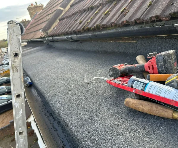 flat-roof-repair-tools-on-roof-london-summit-services-london-ltd